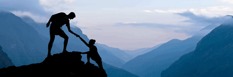 People helping each other to climb a mountain